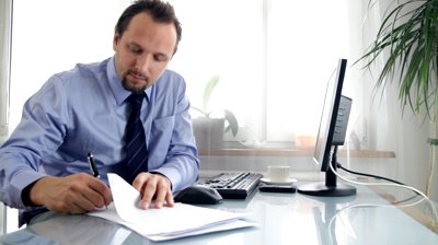 stock-footage-businessman-signing-documents-and-showing-ok-sign